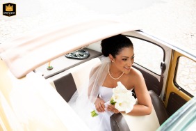 At Le Bistro Gourmet, a striking top-down view through a large sunroof captures the beautiful bride seated in a car, highlighting her elegance and charm from a captivating and unique perspective.